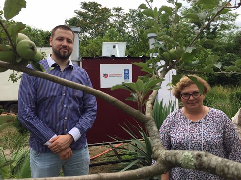 Ms. Lia MuKhashavria, Mr. Jonáš Háger, and back part of Hybrid Solar Dryer